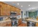 Spacious kitchen featuring granite counters, stainless appliances, and wood cabinets at 4516 Ocean Crest Cir, Raleigh, NC 27603