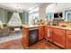Well-designed kitchen with wood cabinets, granite counters, and view into living and dining spaces at 4516 Ocean Crest Cir, Raleigh, NC 27603