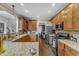 Kitchen features granite countertops, wood cabinets, stainless steel appliances, and seamless flow to other rooms at 4516 Ocean Crest Cir, Raleigh, NC 27603