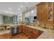 Traditional kitchen featuring granite countertops, light-colored cabinets, and a view into the dining room at 4516 Ocean Crest Cir, Raleigh, NC 27603