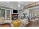 Open-concept living room with fireplace and large windows at 4516 Ocean Crest Cir, Raleigh, NC 27603