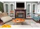 Comfortable living room with a fireplace, custom built-ins, and plush seating at 4516 Ocean Crest Cir, Raleigh, NC 27603