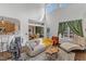 Bright living room with tall windows, neutral colored furniture, and open layout to dining area at 4516 Ocean Crest Cir, Raleigh, NC 27603