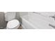 This clean white bathroom includes a toilet and a bright, modern tub and shower combination at 4911 Hollenden Dr # 208, Raleigh, NC 27616
