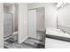 Updated bathroom features a shower, dark wood vanity, and closet at 4911 Hollenden Dr # 208, Raleigh, NC 27616