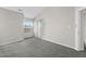 Well-lit bedroom boasts neutral paint and carpeting, with view of sliding glass door at 4911 Hollenden Dr # 208, Raleigh, NC 27616