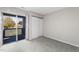 This bedroom features sliding glass doors to a balcony and neutral gray carpet and paint at 4911 Hollenden Dr # 208, Raleigh, NC 27616