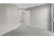 A view of a bedroom with gray walls and carpet, with an open door to an adjoining space at 4911 Hollenden Dr # 208, Raleigh, NC 27616