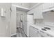 Efficient kitchen design includes washer/dryer, white appliances, white cabinets, and neutral paint at 4911 Hollenden Dr # 208, Raleigh, NC 27616