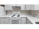 Well-equipped kitchen featuring white appliances, quartz countertops, and white cabinets at 4911 Hollenden Dr # 208, Raleigh, NC 27616