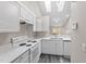 Bright kitchen features all-white cabinetry, appliances, countertops, and neutral paint at 4911 Hollenden Dr # 208, Raleigh, NC 27616