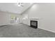 Living room with fireplace, balcony access, neutral paint, and carpet flooring at 4911 Hollenden Dr # 208, Raleigh, NC 27616