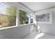 The screened porch with windows showcases the outdoor space of the property at 4911 Hollenden Dr # 208, Raleigh, NC 27616