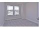 Bedroom featuring a large window and plush carpet at 509 Sherron Rd # 36, Raleigh, NC 27703