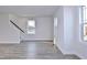 Bright living room featuring hardwood floors, staircase, and large windows at 509 Sherron Rd # 36, Raleigh, NC 27703