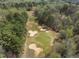 An aerial view of the lush golf course, showcasing manicured greens and strategic sand bunkers, ideal for golf enthusiasts at 5125 Salinas Ct, Holly Springs, NC 27540
