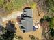 Aerial view of home featuring patio area with outdoor furniture, a fire pit, lush green lawn, and mature trees at 5125 Salinas Ct, Holly Springs, NC 27540