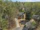 This property features a charming home surrounded by mature trees, with a well-manicured lawn and a circular driveway at 5125 Salinas Ct, Holly Springs, NC 27540