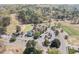 Expansive aerial view of a golf course and clubhouse with parking and lush surroundings at 5125 Salinas Ct, Holly Springs, NC 27540