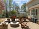 Spacious stone patio with outdoor furniture and a fire pit, perfect for outdoor entertaining at 5125 Salinas Ct, Holly Springs, NC 27540