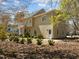 The rear exterior of the home shows lush landscaping and patio area at 5125 Salinas Ct, Holly Springs, NC 27540