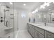 Bright bathroom featuring double sinks, quartz countertops, and a glass enclosed shower at 5125 Salinas Ct, Holly Springs, NC 27540