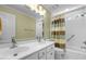 Well-lit bathroom with double vanity, shower, and tub at 5125 Salinas Ct, Holly Springs, NC 27540