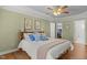 Comfortable bedroom with hardwood floors, light green walls, closet, and en-suite bathroom at 5125 Salinas Ct, Holly Springs, NC 27540