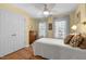 A cozy bedroom with yellow walls, wood floors, and plenty of natural light from the windows at 5125 Salinas Ct, Holly Springs, NC 27540