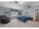 Cozy bedroom with vaulted ceilings, large windows, and comfortable seating area at 5125 Salinas Ct, Holly Springs, NC 27540