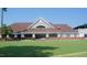 The clubhouse features a sprawling green lawn and a quaint outdoor patio at 5125 Salinas Ct, Holly Springs, NC 27540