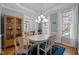 Bright dining room with hardwood floors, a white table, and a built-in china cabinet at 5125 Salinas Ct, Holly Springs, NC 27540