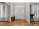 Bright foyer with hardwood floors, white trim, and sidelight windows surrounding the front door at 5125 Salinas Ct, Holly Springs, NC 27540
