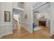 Entryway with hardwood floors, stairs to upper level, and an open doorway into the living room at 5125 Salinas Ct, Holly Springs, NC 27540