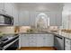 Stylish kitchen with white cabinets, granite countertops, subway tile backsplash, and stainless appliances at 5125 Salinas Ct, Holly Springs, NC 27540