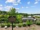 Scenic Bass Lake view with a small waterfall and greenery surroundings at 5125 Salinas Ct, Holly Springs, NC 27540