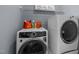 Modern laundry room featuring front-loading washer and dryer at 5125 Salinas Ct, Holly Springs, NC 27540
