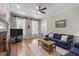 Bright living room with a brick fireplace, hardwood floors, and comfortable sofas at 5125 Salinas Ct, Holly Springs, NC 27540