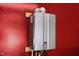 Tankless Rinnai water heater is shown mounted to the wall at 5125 Salinas Ct, Holly Springs, NC 27540