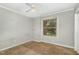Bedroom featuring carpet floors, a ceiling fan, and a window view of the yard at 5324 Rock Quarry Rd, Raleigh, NC 27610