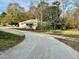 Modest home on a lot filled with trees; foliage obscures much of the home at 5324 Rock Quarry Rd, Raleigh, NC 27610