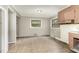 Spacious kitchen area features neutral walls, two windows and older appliances at 5324 Rock Quarry Rd, Raleigh, NC 27610