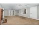 Bright living room with large windows, carpeted floors, and a brick fireplace at 5324 Rock Quarry Rd, Raleigh, NC 27610