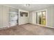 Open living room area with neutral walls and adjoining room in the background at 5324 Rock Quarry Rd, Raleigh, NC 27610