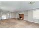 Spacious living room features a brick fireplace, carpeted floors, and neutral paint at 5324 Rock Quarry Rd, Raleigh, NC 27610