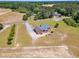 Overhead shot of the brick house with a screened in porch, large green yard, driveway, and trees at 5595 Godwin Lake Rd, Benson, NC 27504