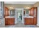 Dual sinks and cabinets with an opening to a walk in closet offer plenty of space in this well-designed bathroom at 5595 Godwin Lake Rd, Benson, NC 27504