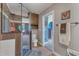 Well lit bathroom featuring a glass shower, toilet, decorative wall art, and towel rack at 5595 Godwin Lake Rd, Benson, NC 27504