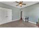 The bedroom includes light blue walls, neutral carpet, a ceiling fan, and closet with double doors at 5595 Godwin Lake Rd, Benson, NC 27504