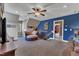 This expansive bonus room features neutral carpet, a ceiling fan, and multiple seating areas at 5595 Godwin Lake Rd, Benson, NC 27504
